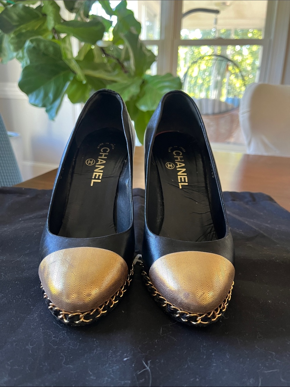 CHANEL Black Leather Pumps with Gold Cap Toe and Chain Trim